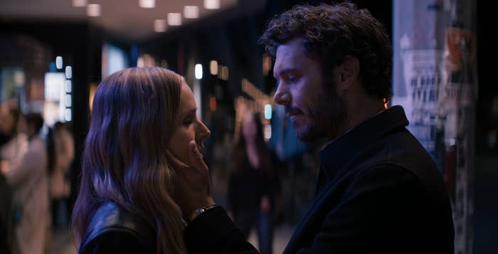 Adam Brody places his hand on Kristen Bell&#x27;s face. They&#x27;re standing on a crowded street