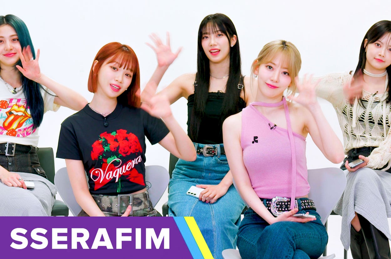 Five members of LE SSERAFIM wave at the camera