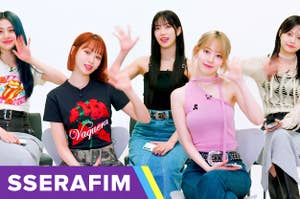 Five members of LE SSERAFIM wave at the camera