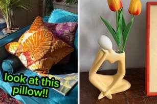 An orange velvet embroidered pillow on the left; on the right, a unique vase holding tulips.