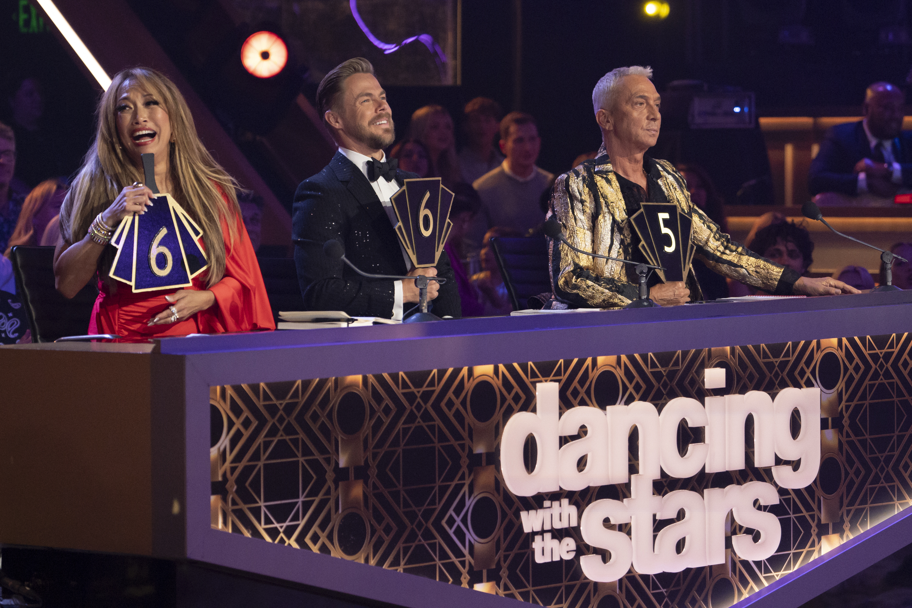 Judges on &quot;Dancing with the Stars&quot; hold up score paddles: woman in long hair with 6, man in tuxedo with 10, and man in sequined jacket with 5