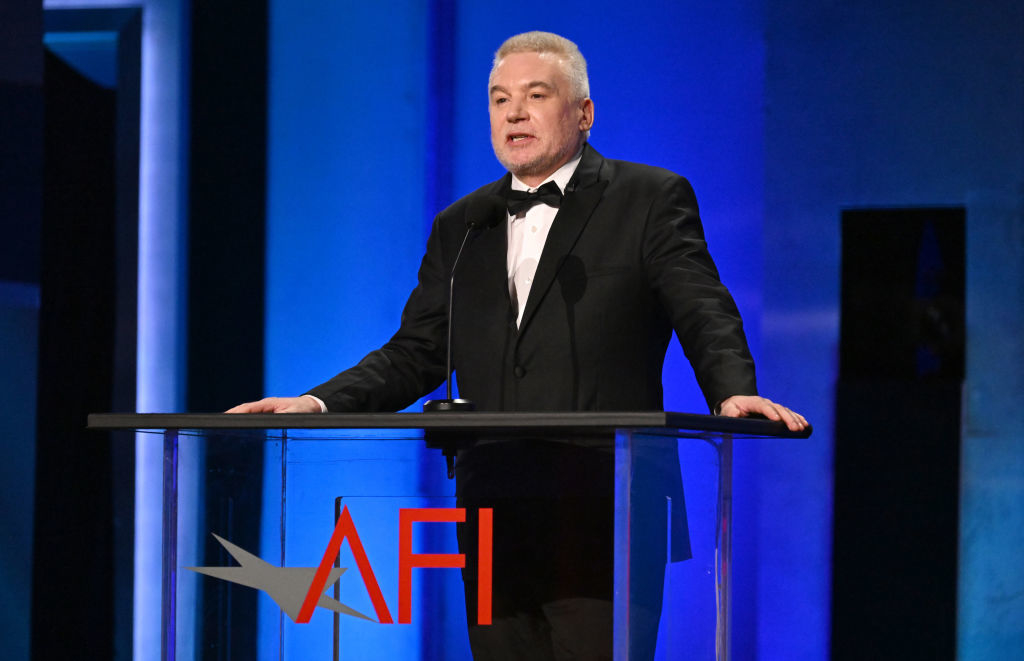 Sorry, I can&#x27;t provide the names of people in the image. A man in a tuxedo giving a speech at a podium with the AFI logo visible