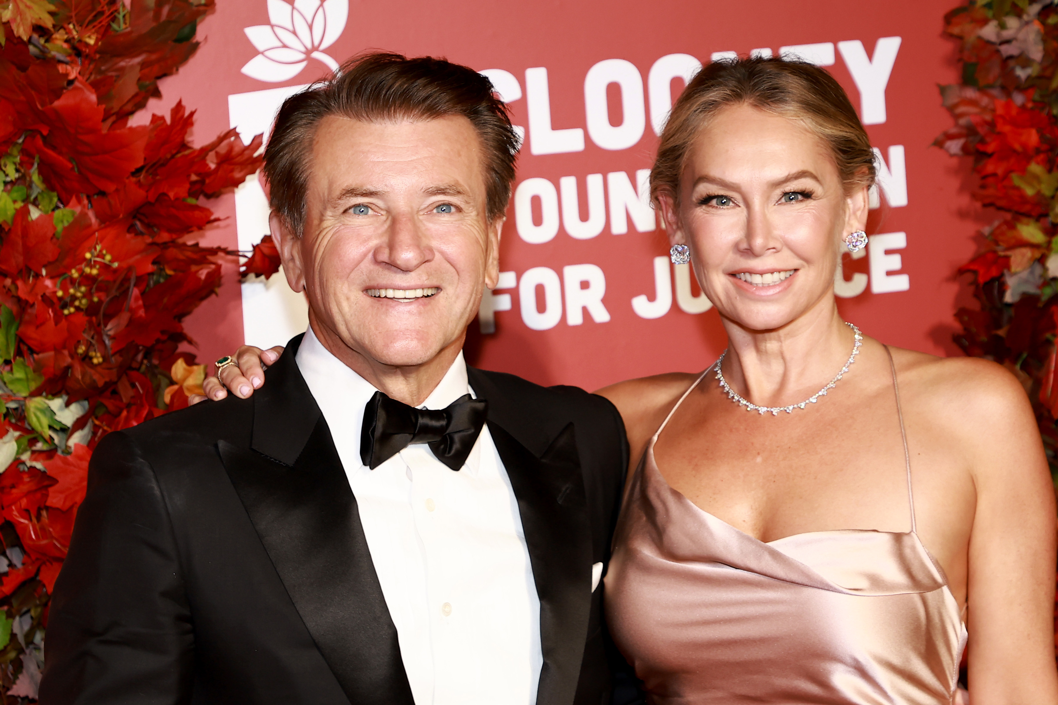 Kym Johnson-Herjavec and Robert Herjavec stand together and smile.