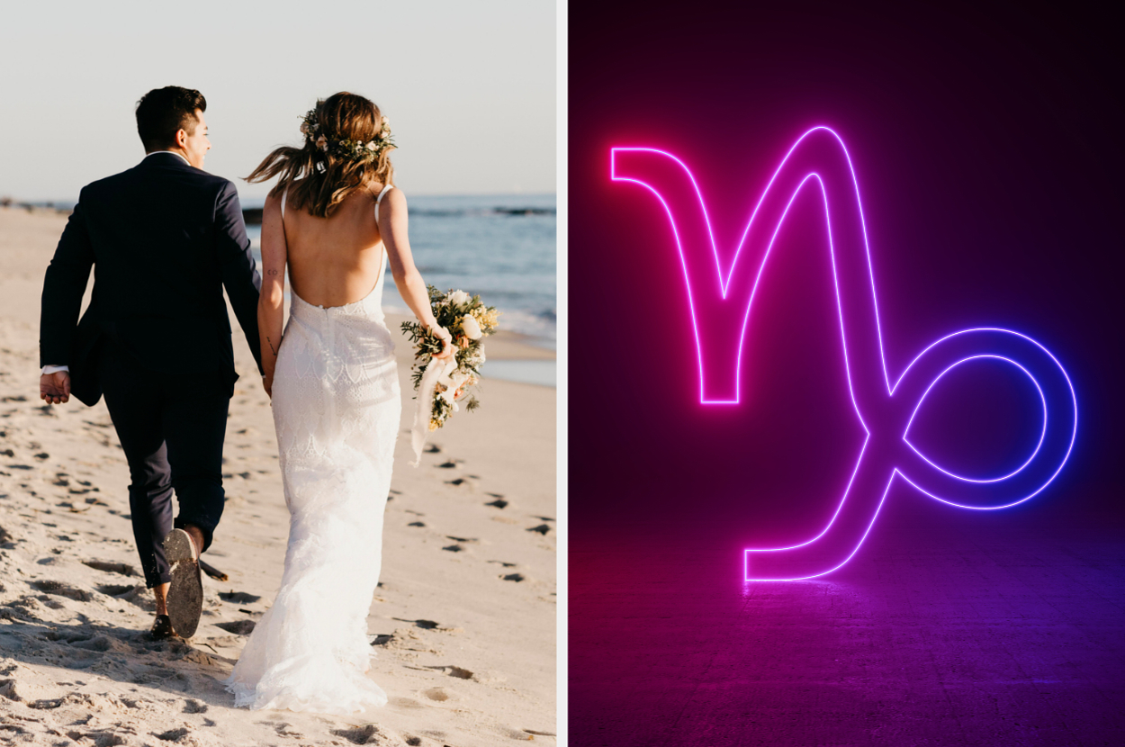 A couple walks on the beach at sunset; woman in a backless dress with flowers. Neon Capricorn symbol glows beside them