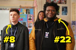 Two TV characters stand in a classroom wearing ID badges. Yellow arrows point to them labeled #8 and #22