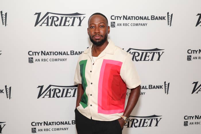 I don't know who the person is, but they are wearing a stylish short-sleeve shirt with a geometric pattern, posing at a Variety event backdrop