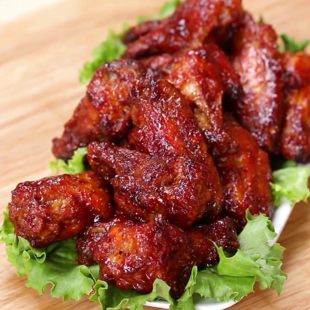 Plate of glazed chicken wings on a bed of lettuce