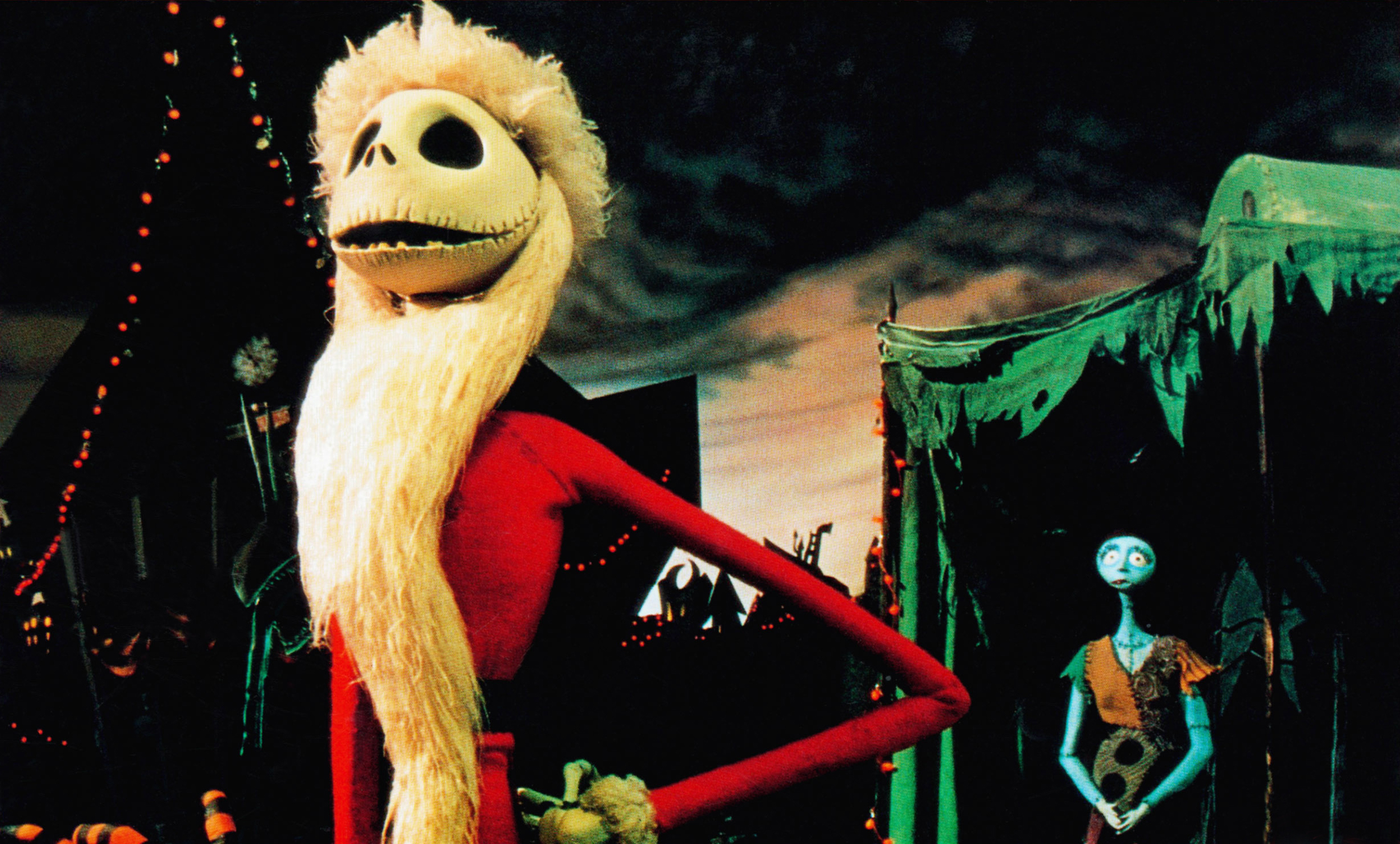 Jack Skellington with a Santa beard stands confidently; Sally is in the background amidst a spooky festive scene