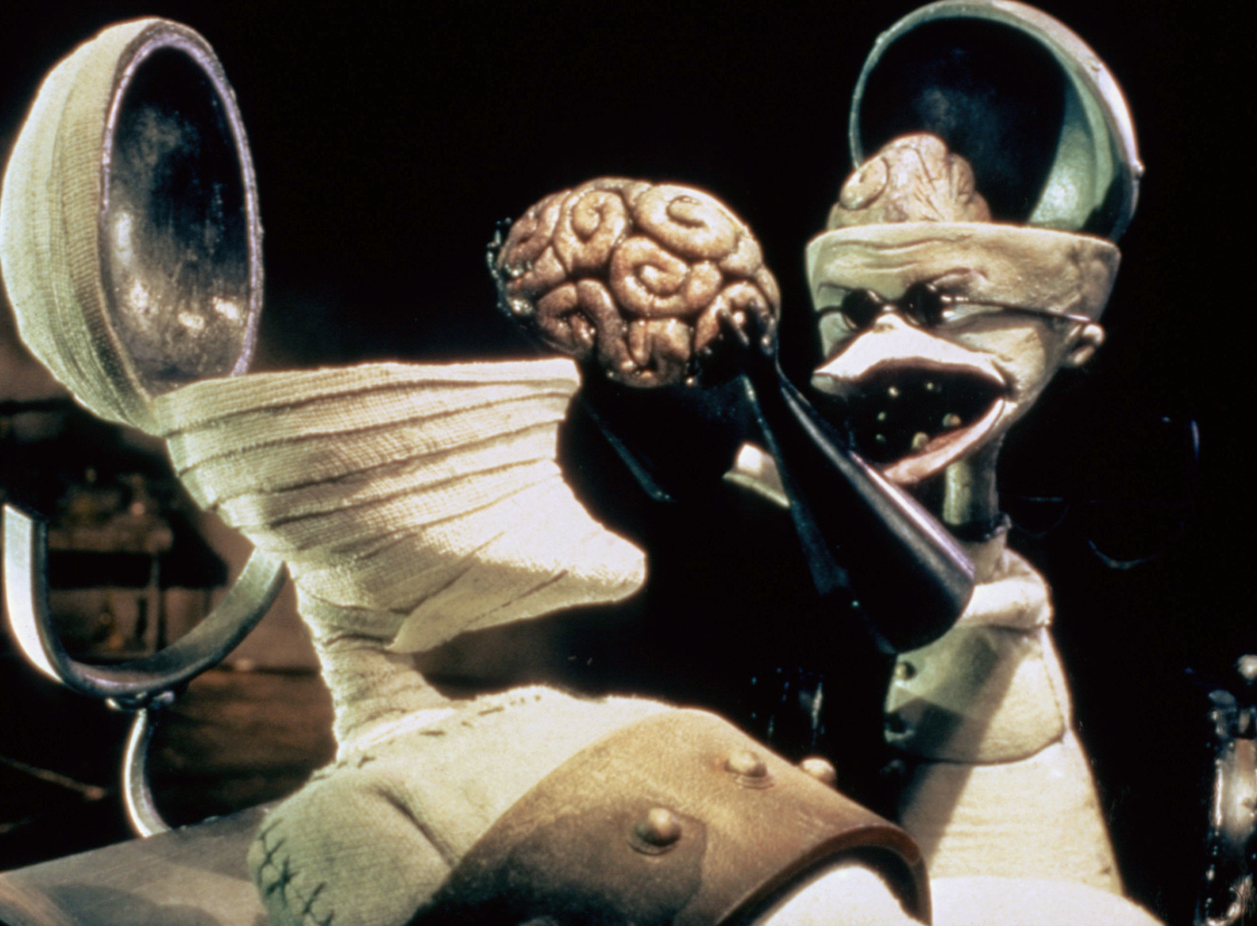 Two characters from &quot;The Nightmare Before Christmas,&quot; Dr. Finkelstein holds his brain while talking to Sally in a laboratory setting