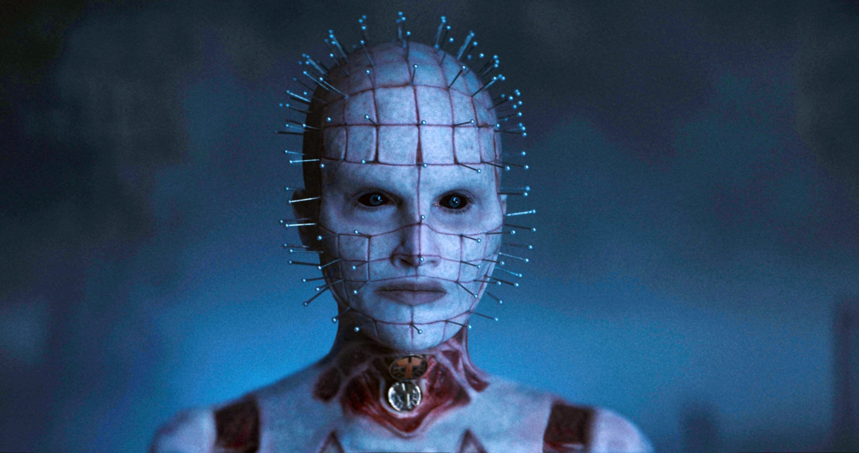 A character from a movie with a grid of pins on their head, pale skin, and a collar