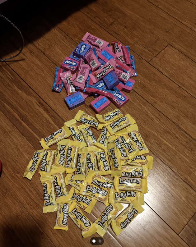 Pile of Laffy Taffy candy in various flavors on a hardwood floor