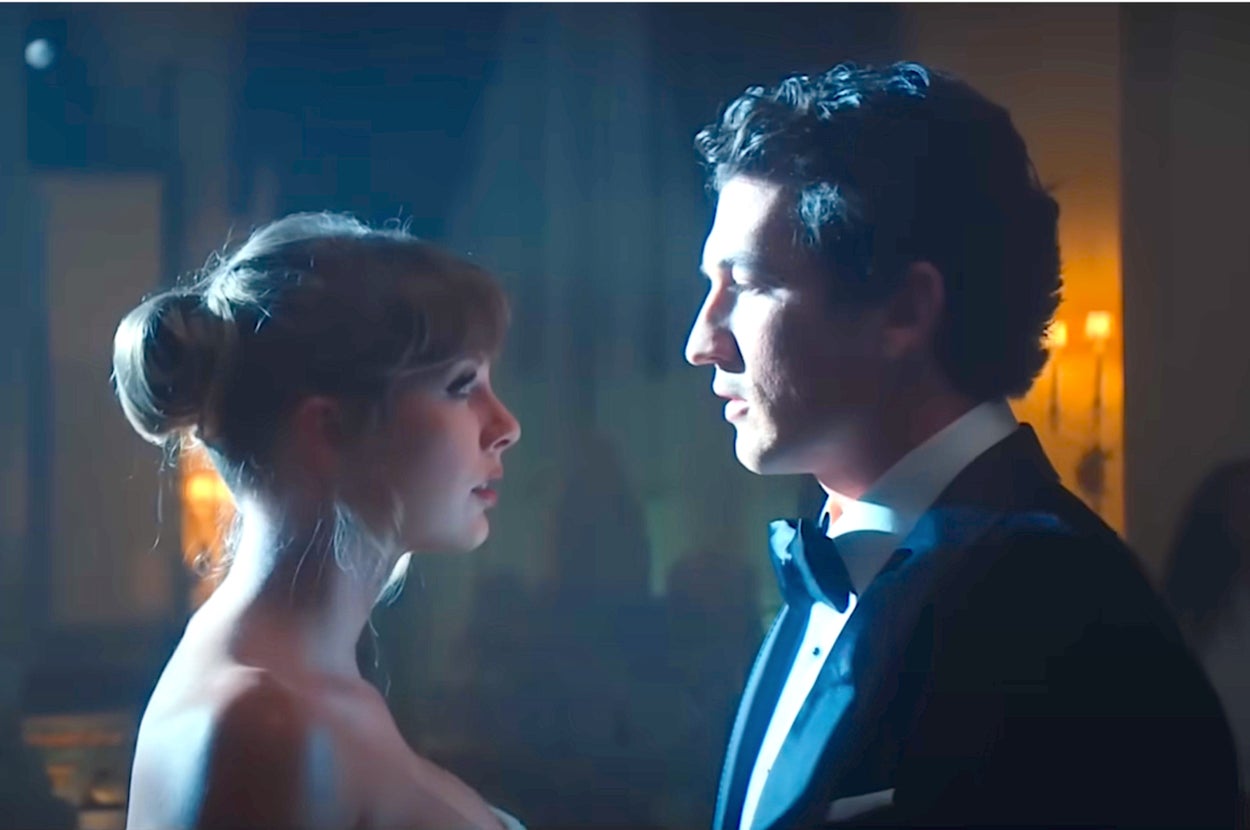 Taylor Swift and Miles Teller in formal wear staring into each other's eyes.
