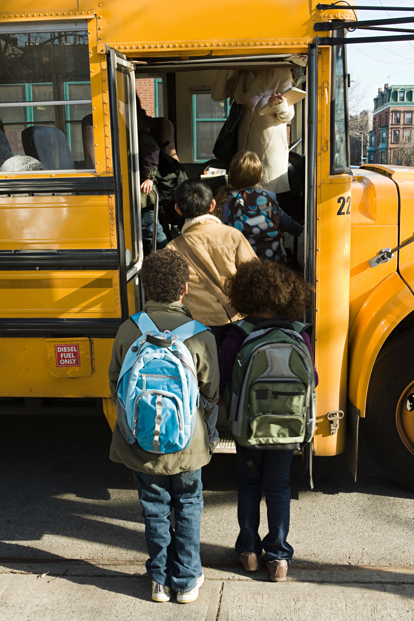 Children with backpacks boarding a school bus