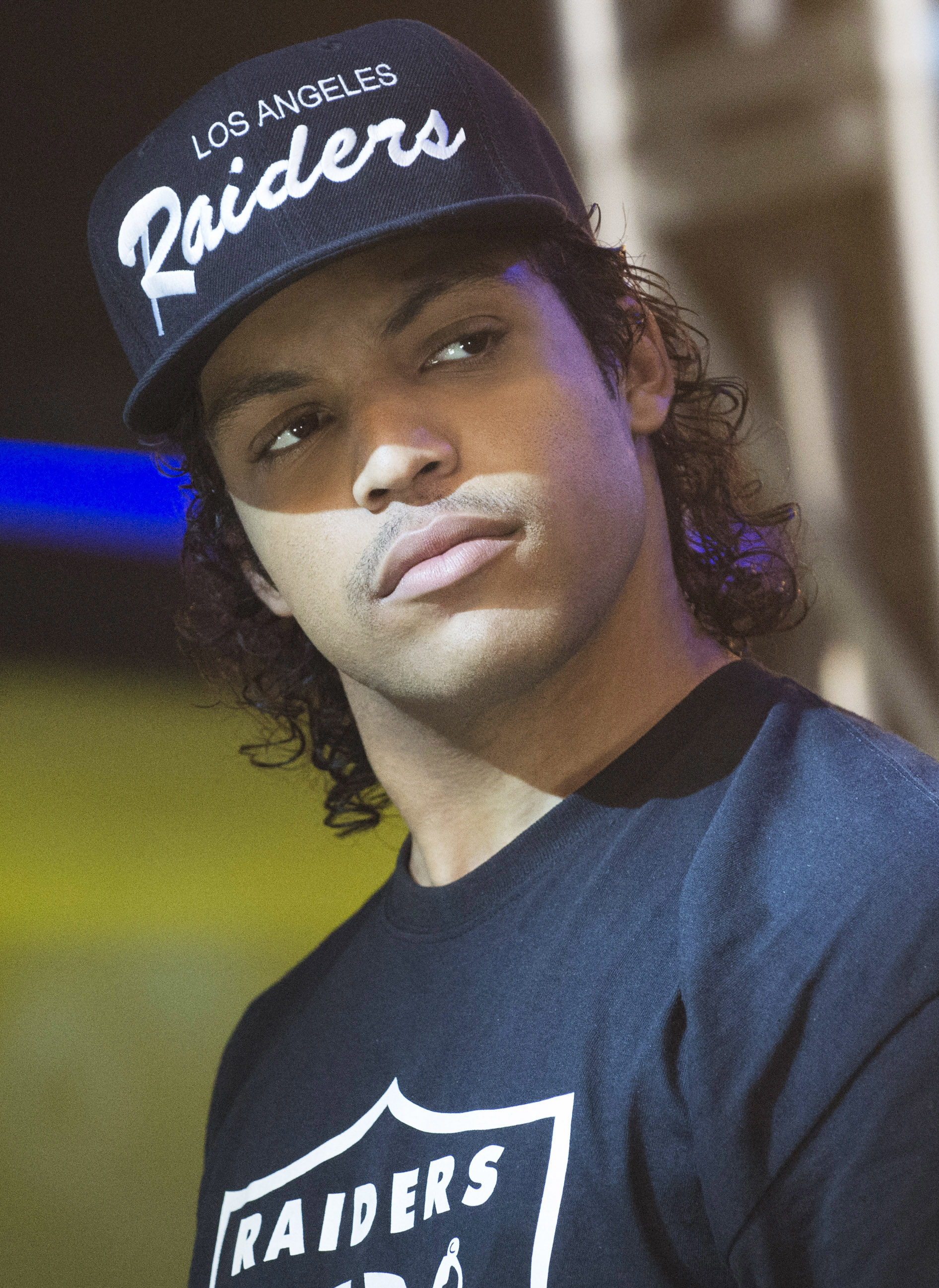 O&#x27;Shea in a &quot;Los Angeles Raiders&quot; cap and matching T-shirt, looking to the side