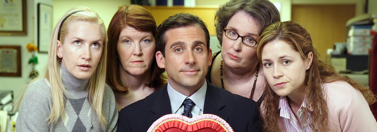 Five people from "The Office" sitcom pose with a heart-shaped Valentine box