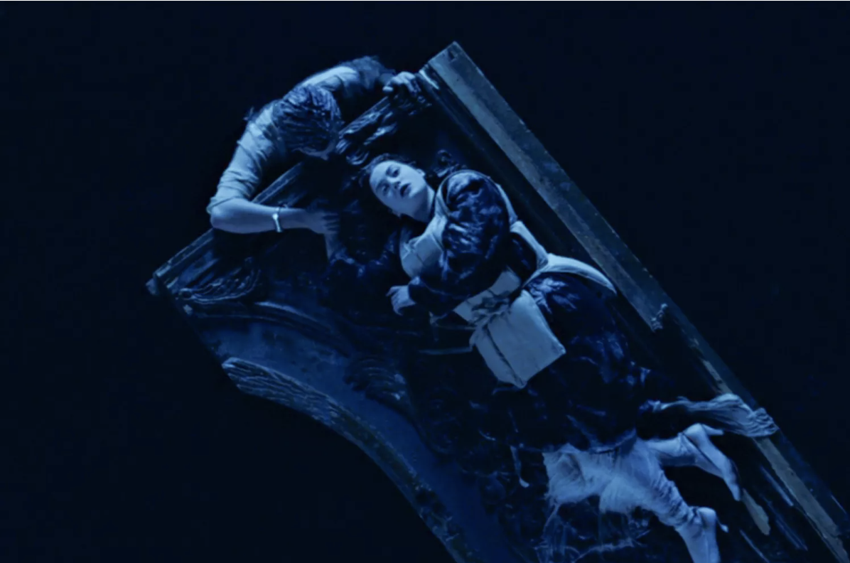 Scene from &quot;Titanic&quot; showing two characters, one on a floating door in the water, depicting a dramatic moment