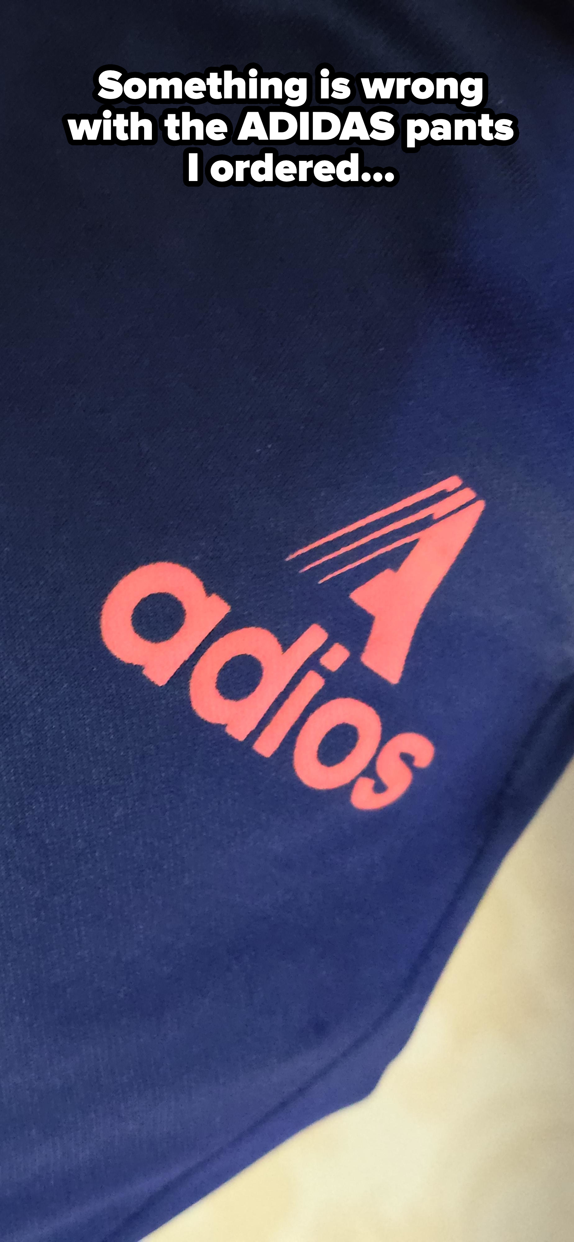 Close-up of a sportswear logo reading &quot;adios&quot; with a stylized letter A