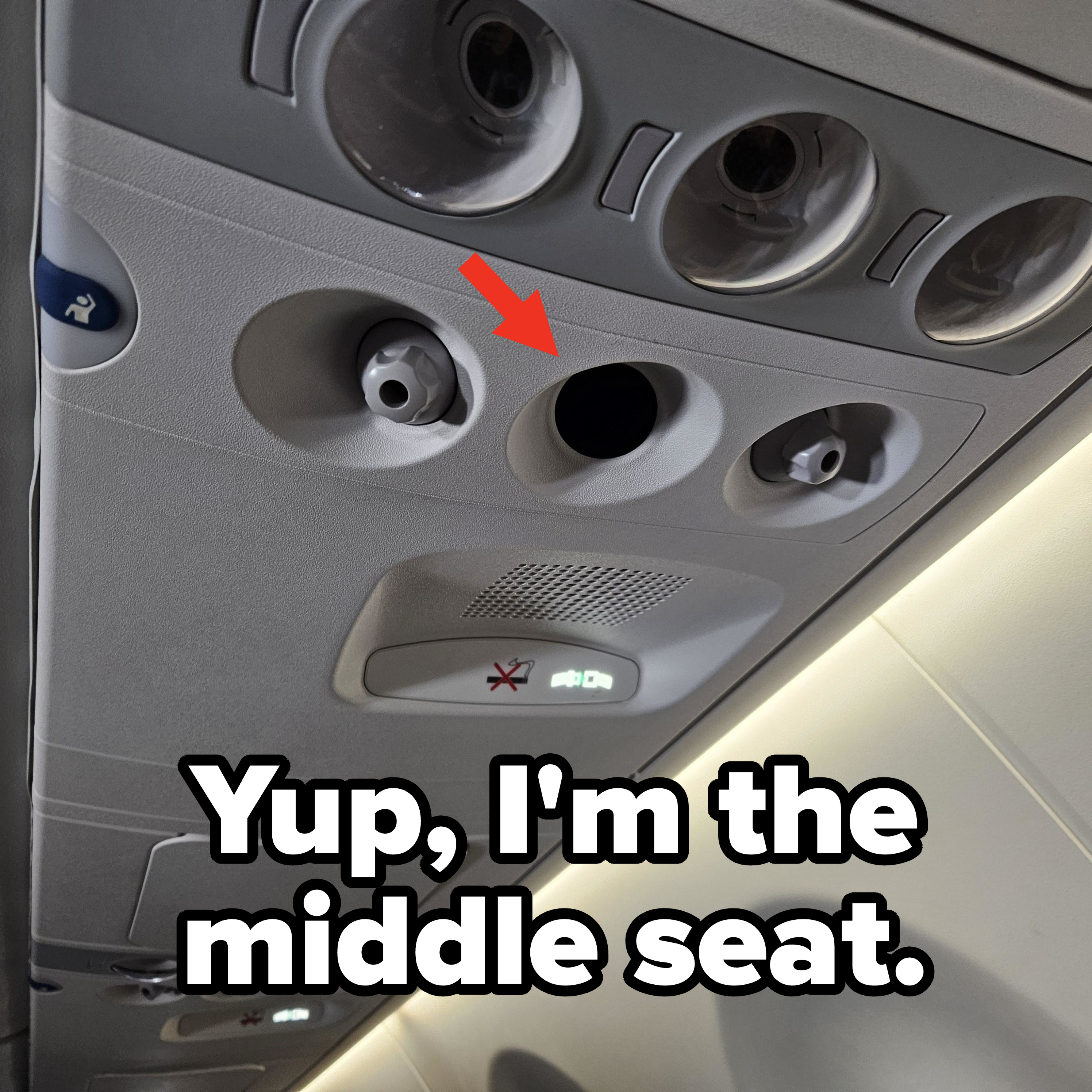 Airplane overhead panel with air vents, flight attendant call button, and no smoking sign