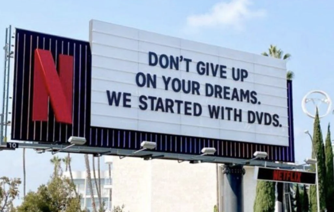 Netflix billboard with text: &quot;Don&#x27;t give up on your dreams. We started with DVDs.&quot;