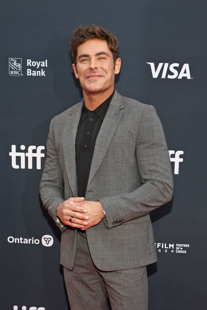 A man in a tailored suit poses at a film festival event