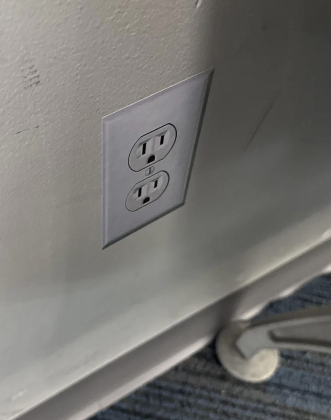 A fake electrical outlet painted on a wall