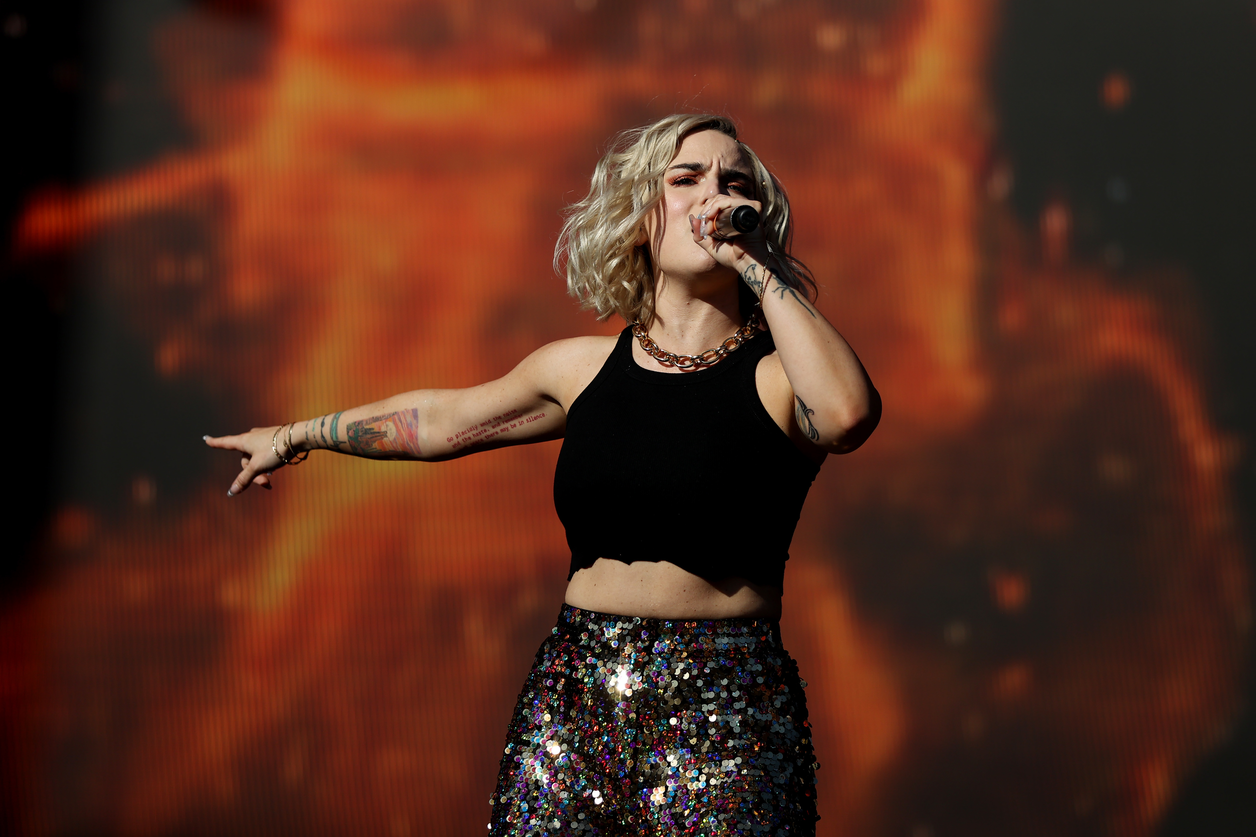 JoJo performs onstage in a crop top and sparkly pants