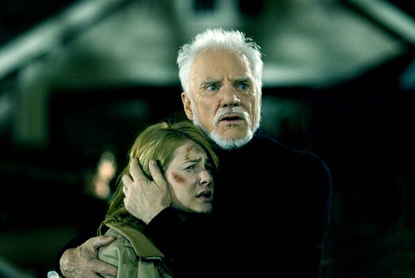 Malcolm McDowell hugging a woman with bruising on her face in &quot;Halloween&quot;