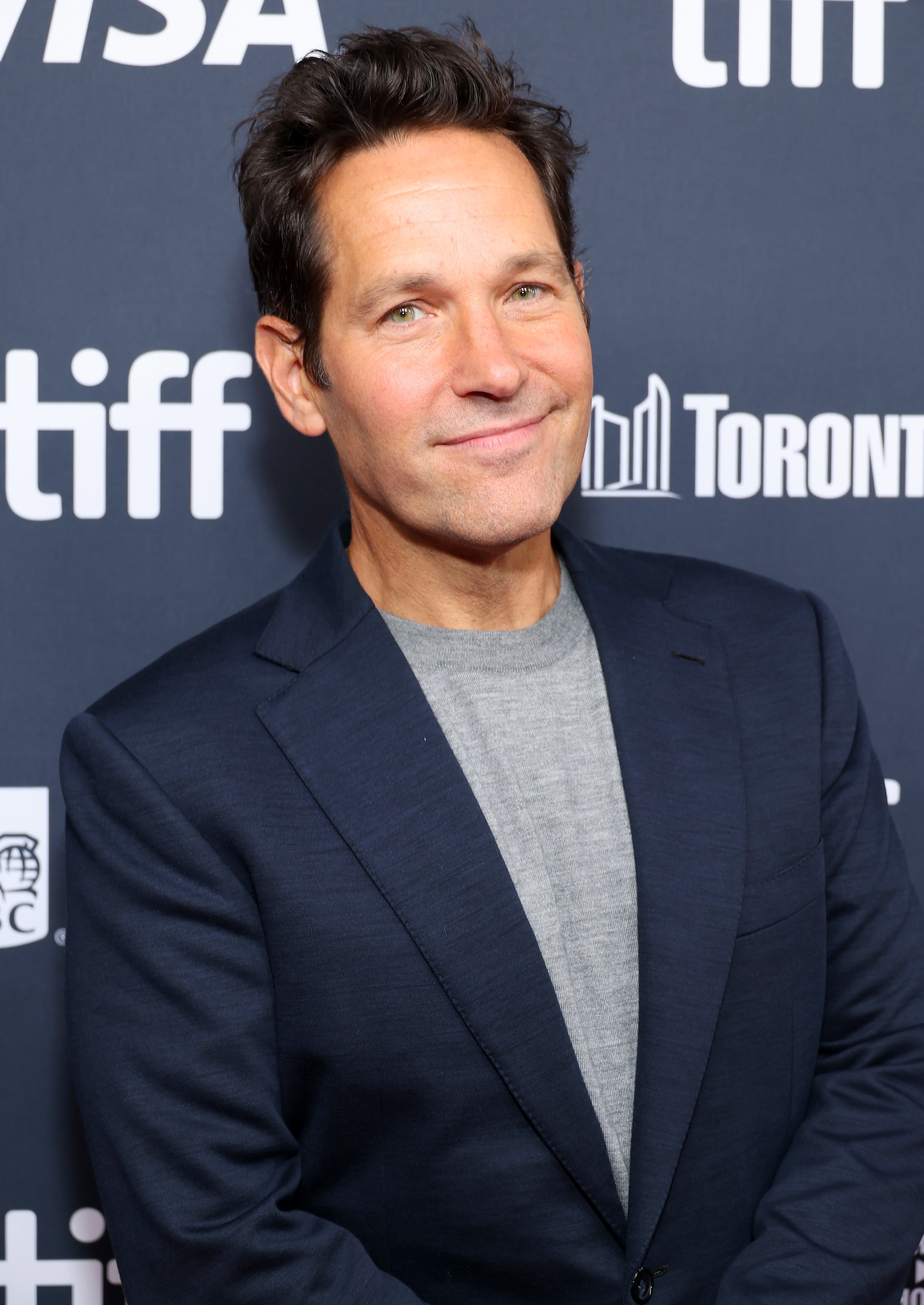 Paul Rudd in a blue blazer and gray shirt on the red carpet for the "Friendship" premiere