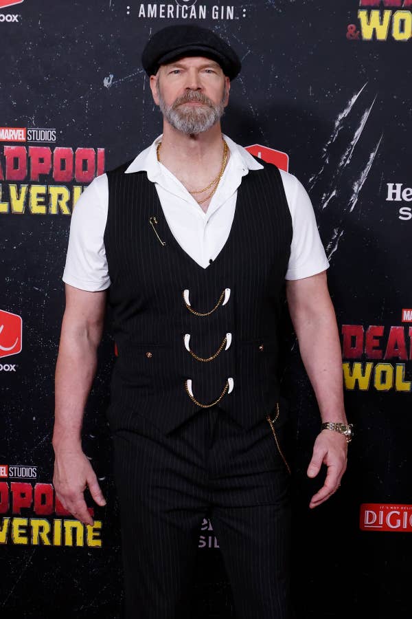 Tyler Mane wearing a pinstripe outfit with a white polo and a newsboy hat on the red carpet for the &quot;Deadpool &amp;amp; Wolverine&quot; premiere