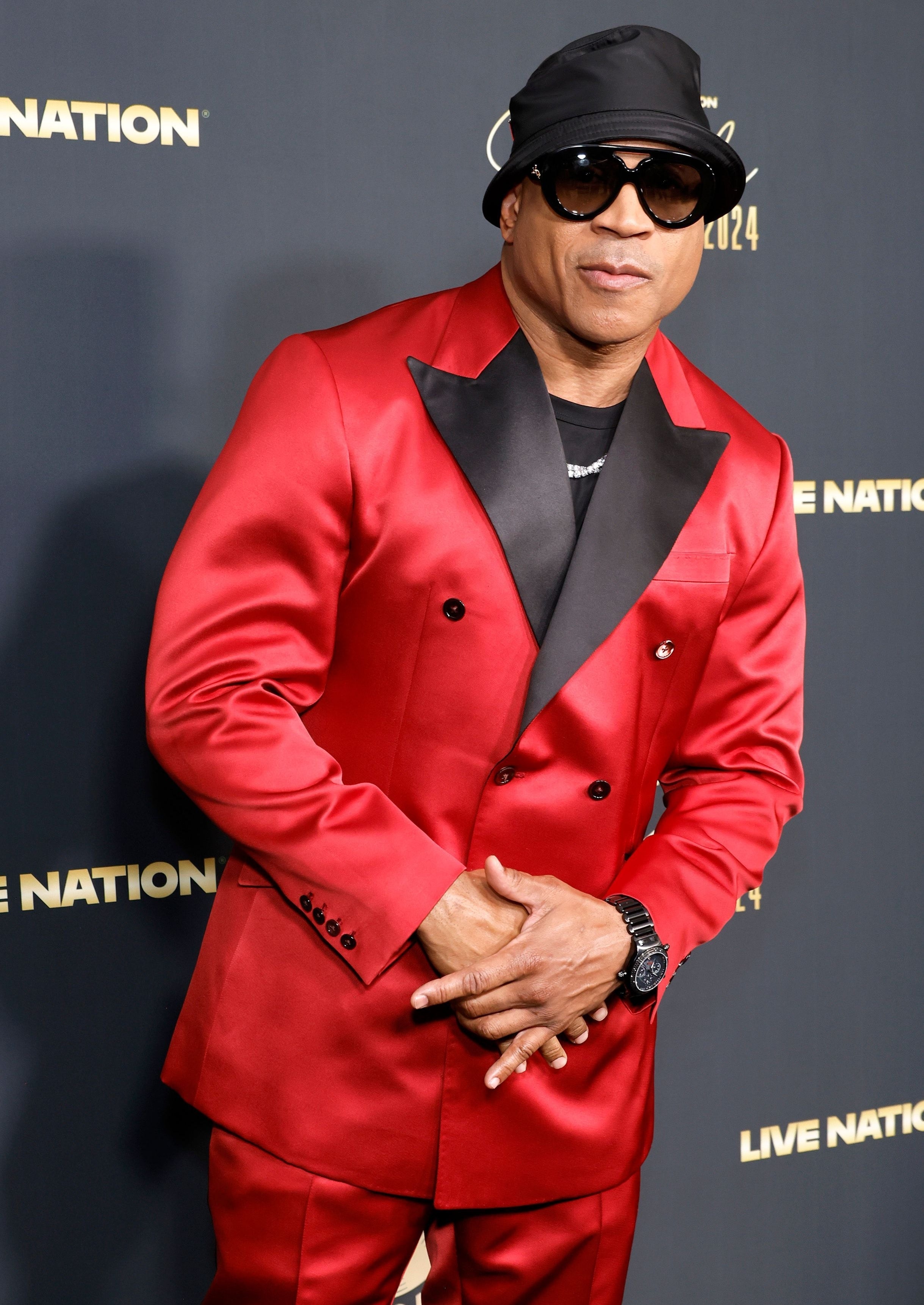 LL Cool J in a red suit, black bucket hat, and sunglasses at the 2024 Black Music Action Coalition Gala