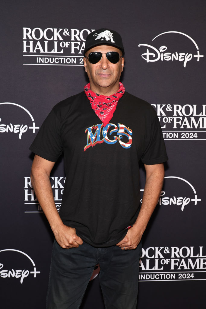 A person wears sunglasses, a bandana, and an MC5 t-shirt at a Rock &amp;amp; Roll Hall of Fame event