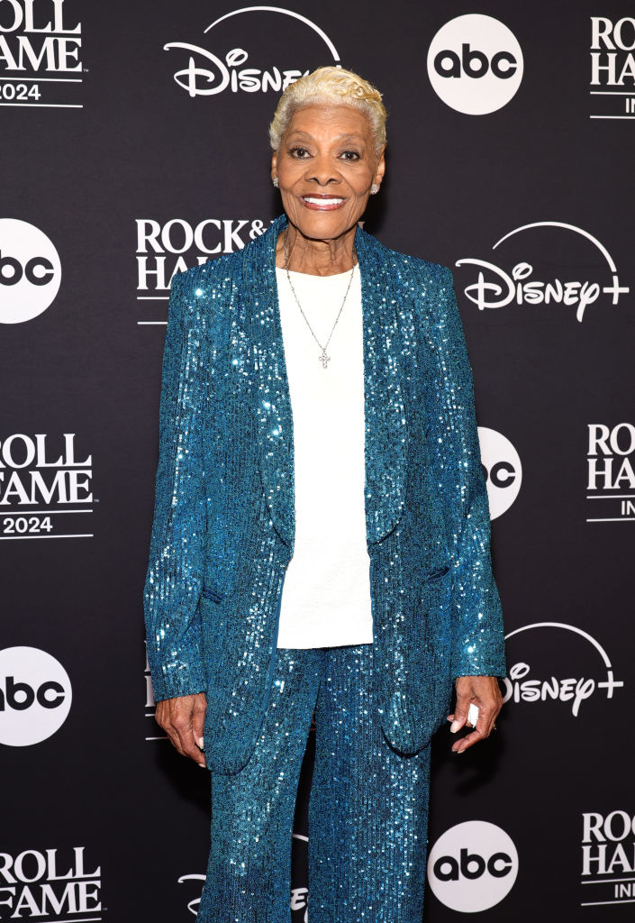 I don’t know who this is. The person is on a red carpet wearing a sparkly suit, standing in front of background logos for ABC, Disney+, and Rock &amp;amp; Roll Hall of Fame