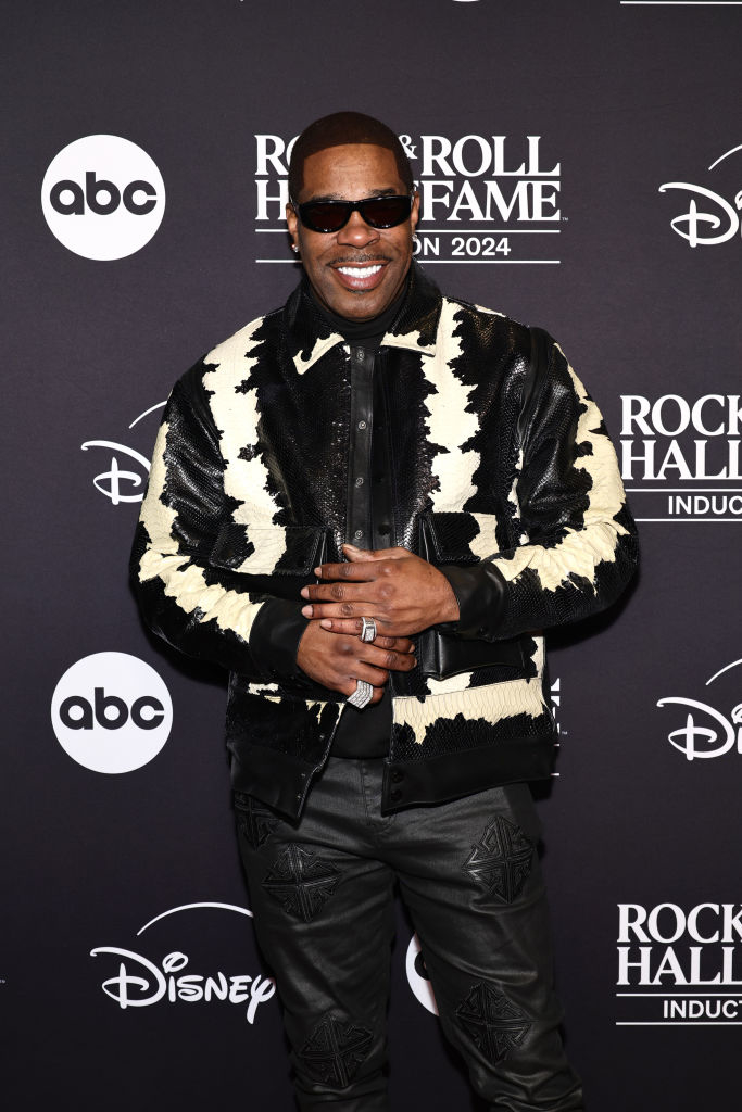 I don&#x27;t know who this is, but the person is on a red carpet wearing a stylish leather jacket and pants with a bold pattern