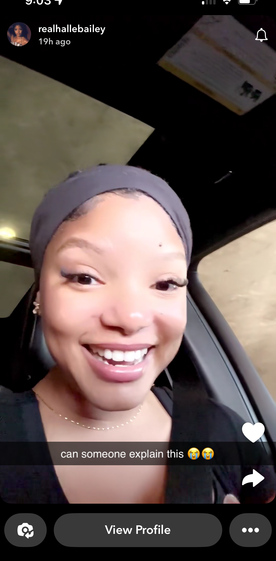 Halle Bailey smiling in a car, wearing a headband. Caption reads, &quot;can someone explain this ??&quot;