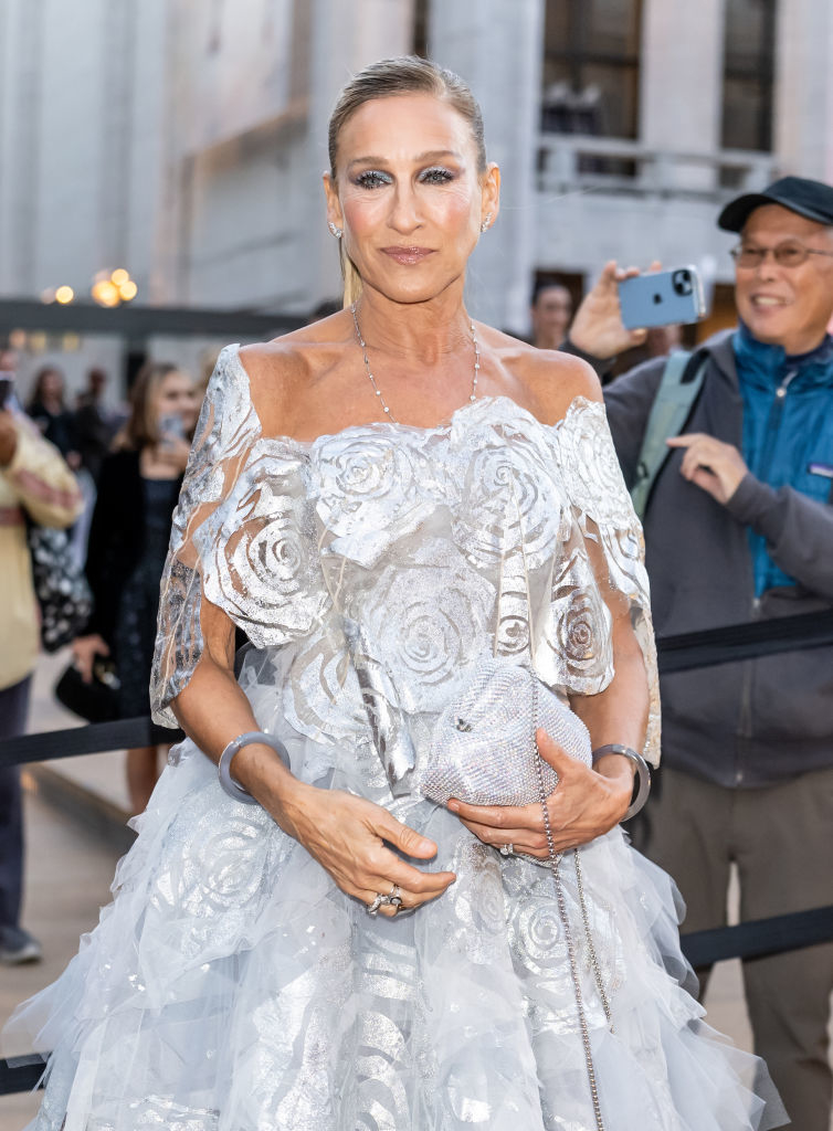 Sarah in a lacy, off-shoulder floral dress and silver jewelry