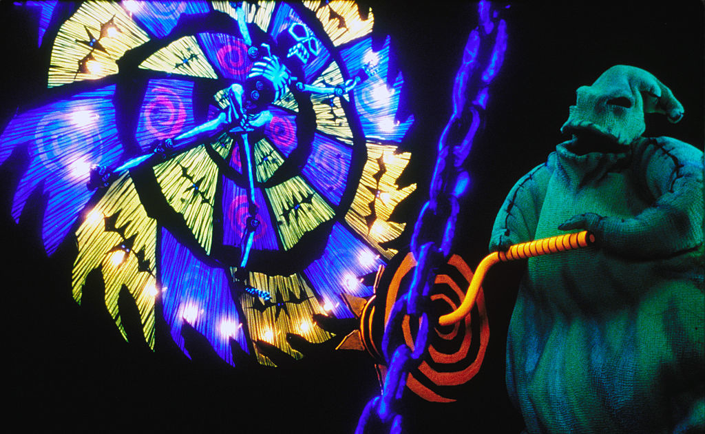 The image features Oogie Boogie and Jack Skellington from &quot;The Nightmare Before Christmas&quot; in a dynamic scene with vivid, swirling patterns