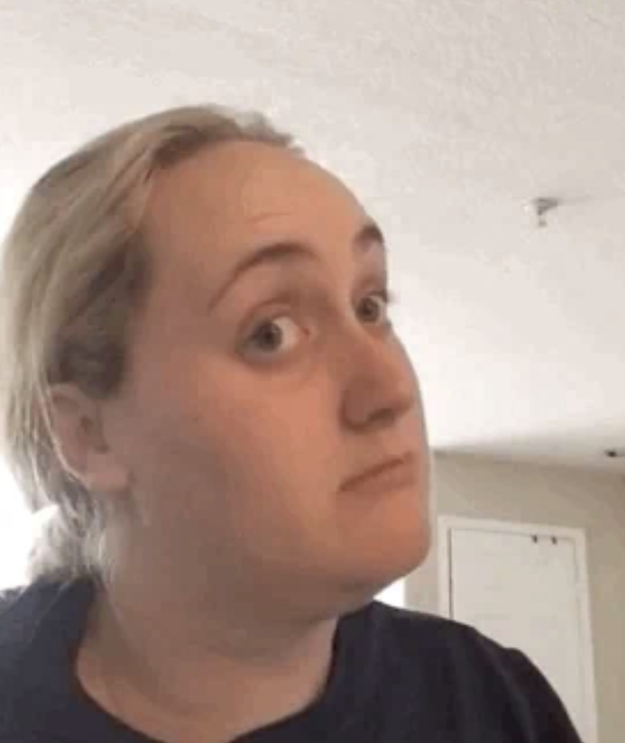 Brittany Broski glances sideways indoors