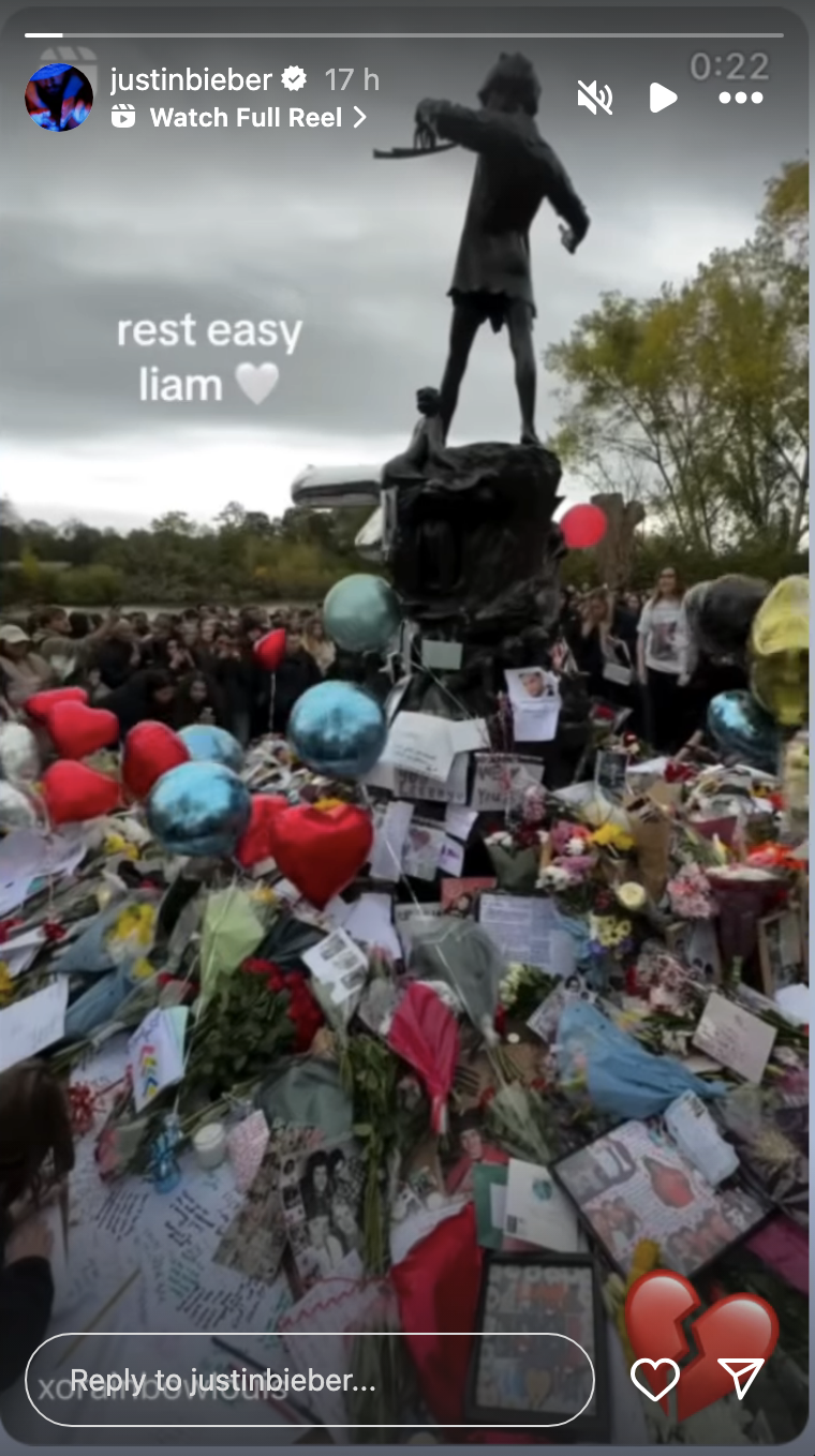 A statue surrounded by flowers, balloons, and notes; text reads &quot;rest easy Liam&quot; with heart emoji. Instagram story by Justin Bieber