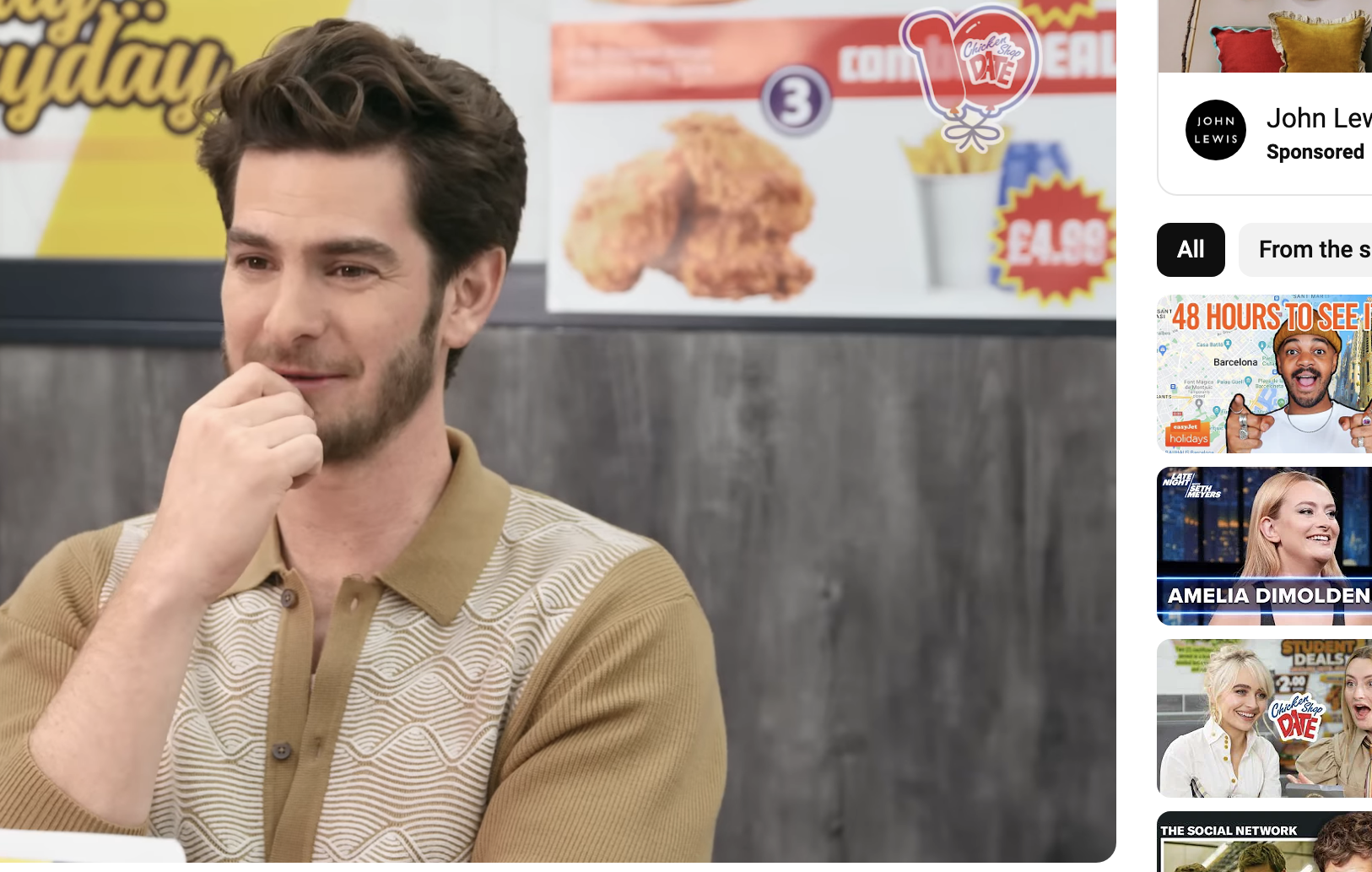 Andrew Garfield, wearing a patterned polo shirt, appears on Chicken Shop Date with Amelia Dimoldenberg. YouTube video page showing views and likes