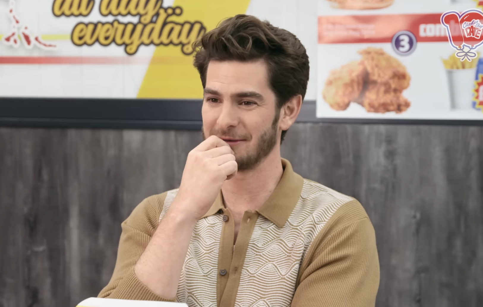 Andrew Garfield, wearing a patterned polo shirt, appears on Chicken Shop Date with Amelia Dimoldenberg. YouTube video page showing views and likes