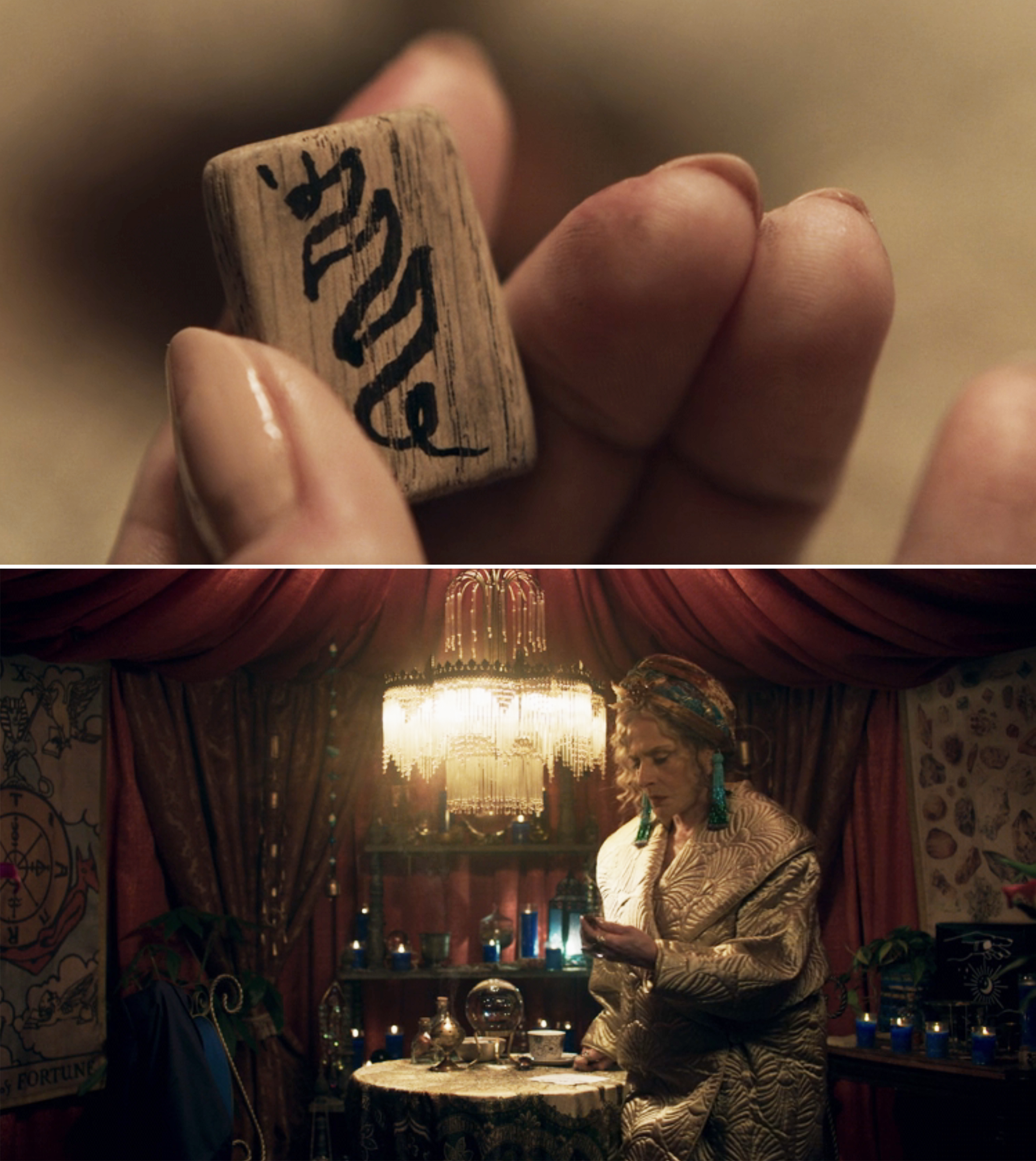 A close-up of Lilia holding a small piece of wood with a sigil drawn across it