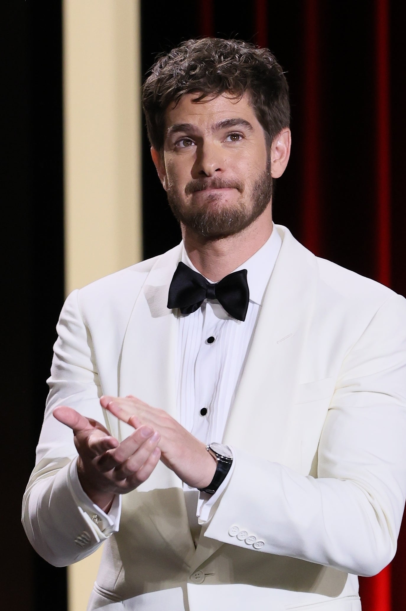 Andrew in a tuxedo clapping