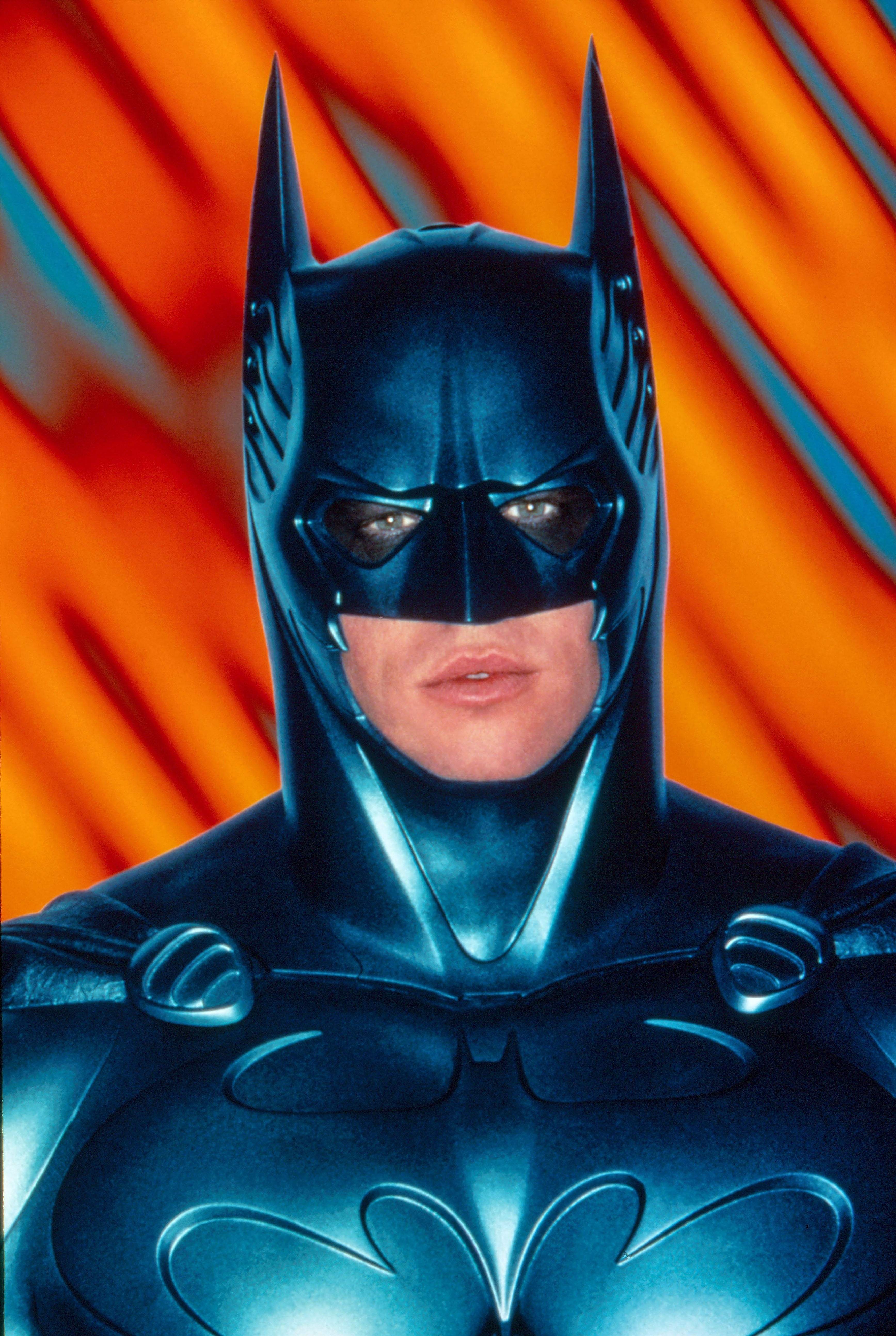 Batman stands in a dramatic, stylized costume with pointed ears and a bat emblem on the chest