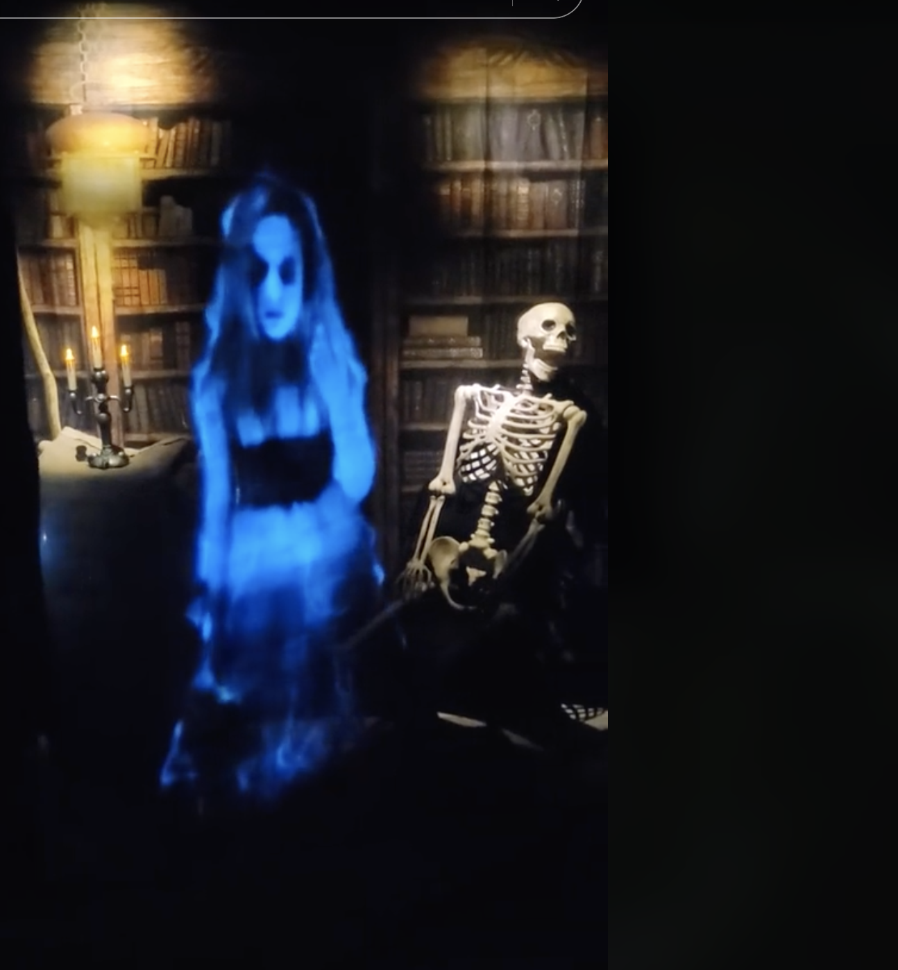 Ghostly figure and skeleton in a dimly lit library setting with candles