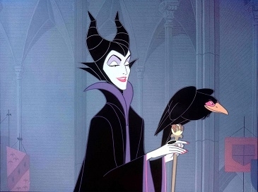 Maleficent, in a flowing, gothic outfit, stands with a staff topped by a perched raven