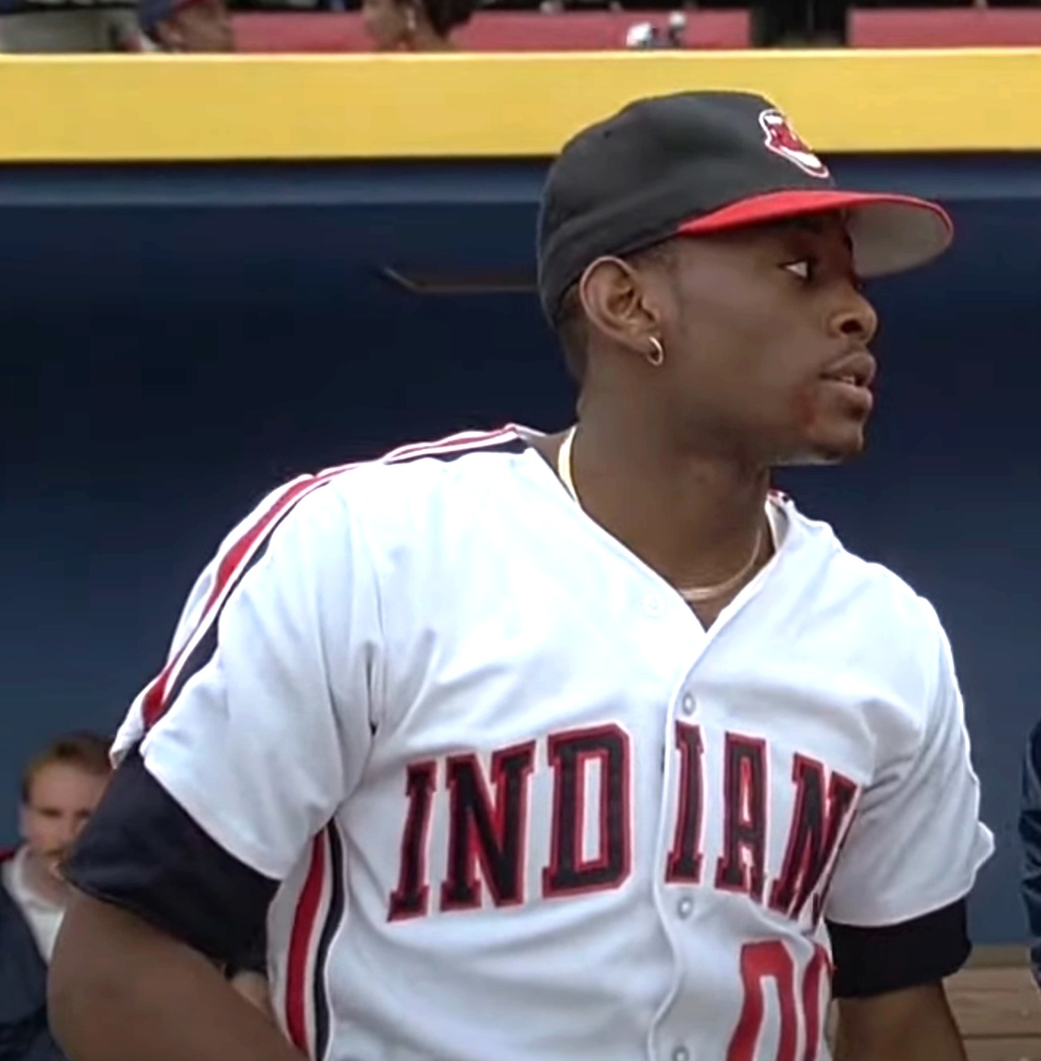 Omar stands in a baseball uniform with &quot;INDIANS&quot; visible on the jersey