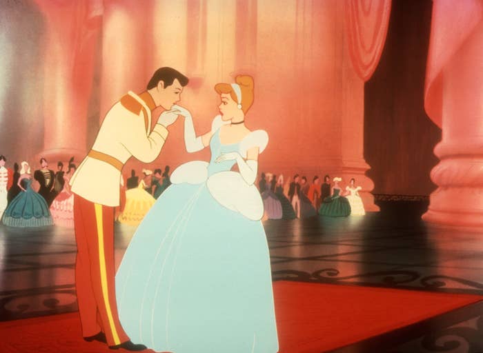 Cinderella and Prince Charming at a royal ball, bowing and holding hands, surrounded by elegantly dressed guests