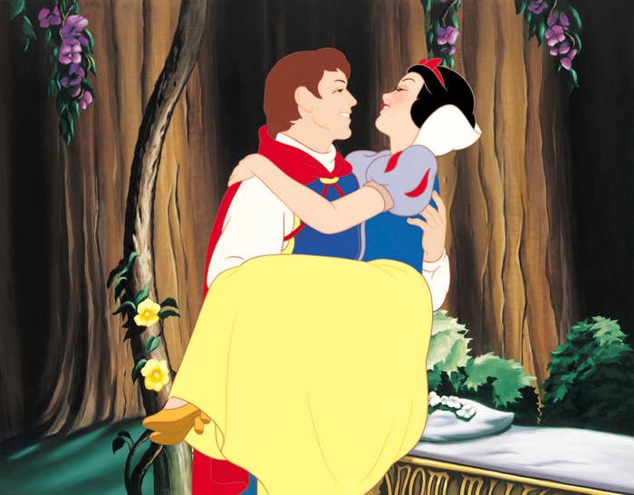 Snow White and Prince Charming embrace in a forest scene, wearing classic fairy tale attire