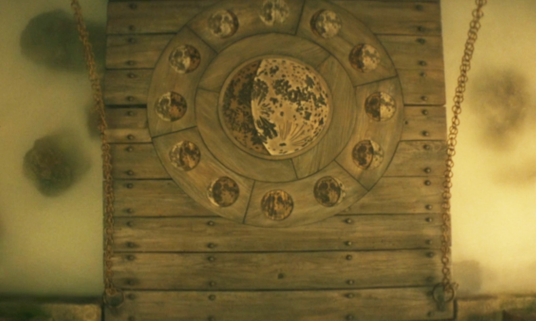 A close up of the phases of the moon on a wooden drawbridge