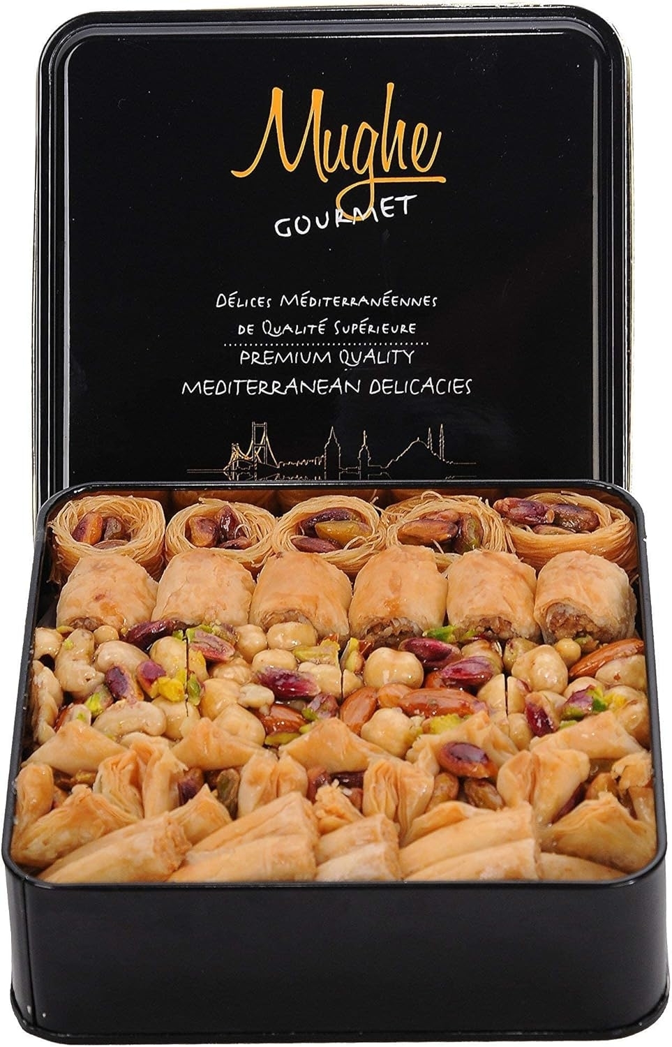 An open tin of assorted Mediterranean pastries including baklava and other nut-filled delights. Lid displays brand name and describes product quality